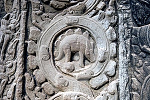 Sculpted stone depicting a dinosaur at the ancient Ta Prohm temple at Angkor Wat.