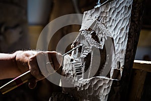 Sculptor hands working wood