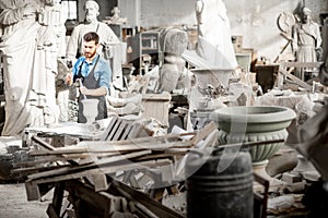 Sculptor working with sculptuers in the studio