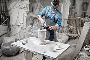 Sculptor working with sculptures in the studio