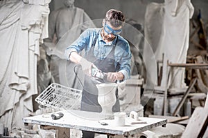 Sculptor working with sculptures in the studio