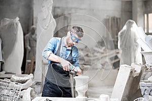 Sculptor working with sculptures in the studio