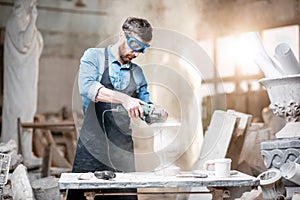 Sculptor working with sculptures in the studio