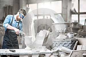 Sculptor working with sculptures in the studio