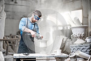 Sculptor working with sculptures in the studio photo