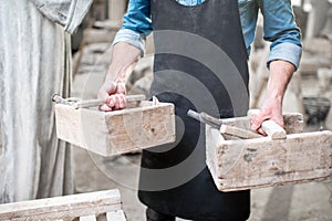 Sculptor with working tools in the studio