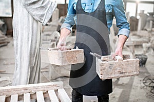 Sculptor with working tools in the studio