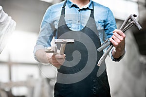 Sculptor with working tools in the studio