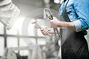 Sculptor with working tools in the studio