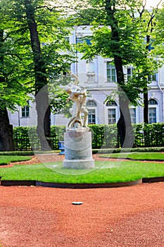 Sculptural composition Kidnapping of Sabine Woman in old city park Summer Garden in St. Petersburg, Russia