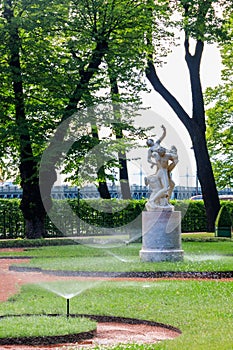 Sculptural composition Kidnapping of the Sabine Woman in old city park Summer Garden in St. Petersburg, Russia