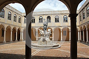 Sculptural group inside an arcaded courtyard photo