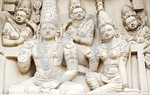 Sculptural images of Shiva, Parvati and other gods on the wall of an ancient Indian temple