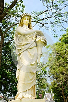 Sculpture of ancient lady in the garden.