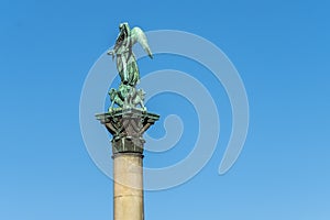 Sculpture of an angel with 4 lions on a pillar - Jubilaumssaule Pillar on Schlossplatz Square in front of the Neues