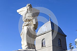Sculpture of an angel on the background of the Church of the Exaltation of the Holy Cross of the XVI century in Ternopil  Ukraine