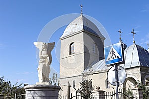 Sculpture of an angel on the background of the Church of the Exaltation of the Holy Cross of the XVI century in Ternopil  Ukraine.