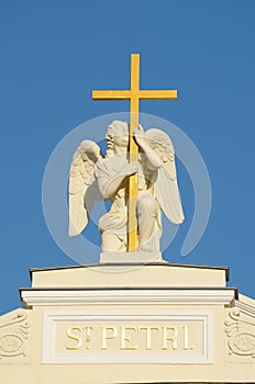Sculpture of an angel with a cross.