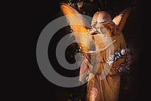 Sculpture of an angel with dark background