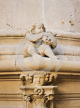 Sculpture of an angel and a skull in Burgos Cathedral photo