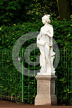 Sculpture of antique european sibyl in summer garden