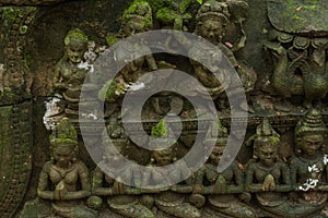 A sculpture of Apsara with a mossy island at Ta Phrom Temple, Angkor Wat, Siem Reap