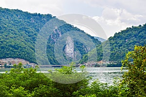 Sculpture bas-relief of the Dacian king Decebal, located on the rocky bank of the Danube in Romania. View from the coast of Serbia