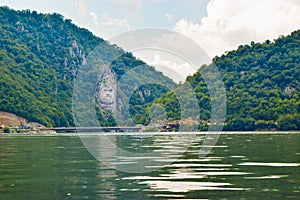 Sculpture bas-relief of the Dacian king Decebal, located on the rocky bank of the Danube in Romania. View from the coast of Serbia