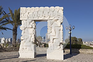 Sculpture `A belief gate ` in Abrasha park in Yaffo with overlooking Tel Aviv in the background, photo