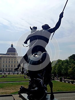 Sculpture in Berlin Mitte with museum in the background