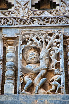 Sculpture of Bhima shaking the tree and Kauravas are falling down. Chennakeshava temple. Belur, Karnataka. An episode from Mahabha