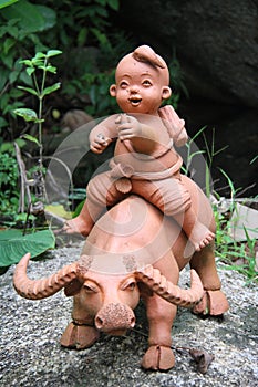 Sculpture of a boy riding waret buffalo