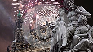 Sculpture on the Bruhl Terrace and Hofkirche or Cathedral of Holy Trinity and holiday fireworks - baroque church in Dresden