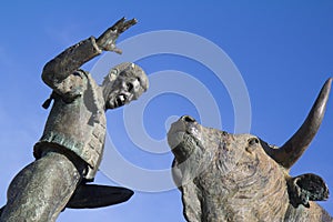 Sculpture of a bullfighter in front of his fight b photo