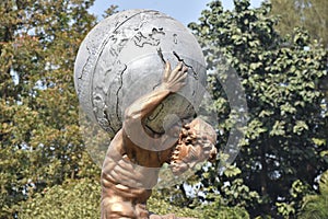 Sculpture carrying Earth Globe on his shoulders