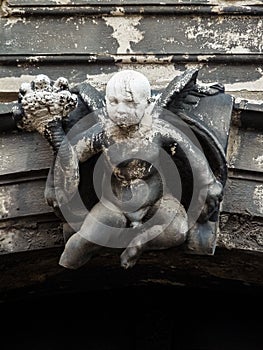 A sculpture of a cherub that has succumbed to the passage of time in Venice. Italy