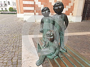 Sculpture of children sitting on a bench