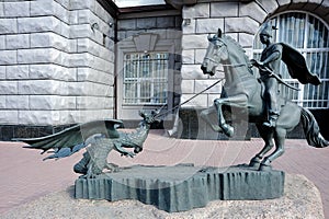 Sculpture of a cossack conquers a serpent in Kyiv Ukraine photo