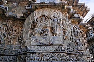 Sculpture of dancing Shiva on the centre left and Vishnu on the right, west side walls, Hoysaleshwara temple, Halebidu, Karnataka.