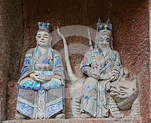 Statue of Taoist deity or god of wealth, Zhao Gongming, and his wife at Dazu Rock Carvings