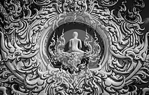 Sculpture detail with white Buddha in all-white buddhist temple Wat Rong Khun in Chiang Rai, Thailand