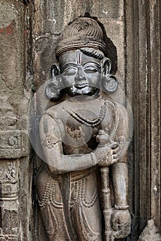 Sculpture of Dwarpala on the wall of Trishund Mayureshshwar Ganesh Temple at Somawar Peth photo