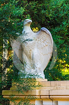 Sculpture of eagle among branches of bush