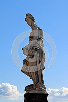 Statue of Primavera on the bridge Ponte Santa Trinita seen against blue sky, Florence, Italy photo