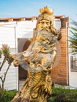 Sculpture of the god of water Neptune from a tree on the sea Russia in Sochi