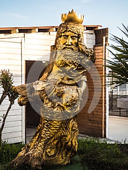 Sculpture of the god of water Neptune from a tree on the sea Russia in Sochi