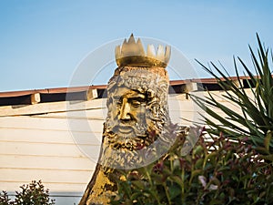 Sculpture of the god of water Neptune from a tree on the sea in Sochi 09.05.2019