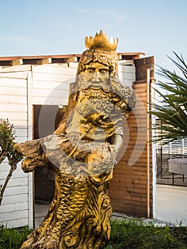 Sculpture of the god of water Neptune from a tree on the sea in Sochi 09.05.2019