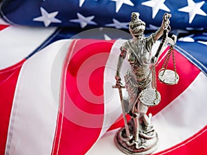 Sculpture of the goddess of justice - Themis on the state American flag. Constitution, court, rule of law, punishment for crimes,