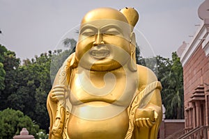 Sculpture of Golden laughing Buddha Buddhist monastery at Sarnath, Varanasi